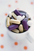 Many Assorted Vitamins in a Mug