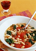 Bowl of Chicken White Bean and Spinach Stew with Spoon