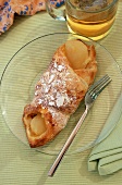 Apple Turnover on a Plate with a Glass of Tea