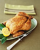 Whole Roasted Chicken on a Platter with Lemons