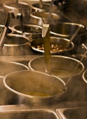 A Variety of Steaming Sauce Pot with Ladels in a Restaurant Kitchen
