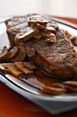 Close Up of Top Sirloin Steak with Mushrooms and Au Jus Sauce