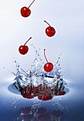 Cherries falling into water