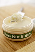 Opened Container of Shea Nut Butter with Knife, Close Up