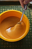 Stirring a Bowl of Homemade French Dressing