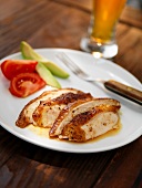 Sliced Grilled Chicken Breast on a White Plate; Glass of Beer