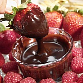 Dipping a Strawberry into Melted Chocolate