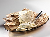 A Wedge of Blue Cheese with Crackers and Spreading Knife