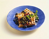 Waffles with Blueberry Topping on a Blue Plate, White Background