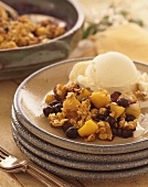 Peach Blueberry Crumble with a Scoop of Vanilla Ice Cream on a Stack of Plates