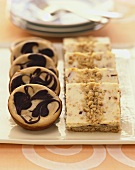 Individual Chocolate Swirl Cheesecakes and Nut Crumble Bars on a Platter