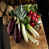 Various Vegetables on a Cutting Board with Salt and Pepper