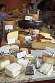 Display of cheeses on a market stall
