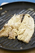 Two Pompano Fish Fillets on a Grill Pan