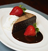 Slice of Chocolate Cake with Chocolate Sauce, Strawberries and Ice Cream