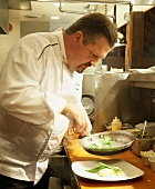 Chef Preparing Food in a Restaurant Kitchen