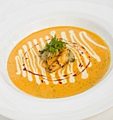 Bowl of Squash Soup Topped with Shrimp on White Plate