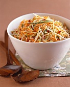 Crunchy Julienned Vegetable Slaw in a White Bowl with Wooden Servers