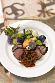 Sliced Sirloin Steak on a White Plate with Vegetables