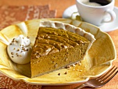 Slice of Pumpkin Pie on a Plate with Whipped Cream