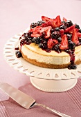 Cheesecake Topped with Assorted Berries on a Cake Plate