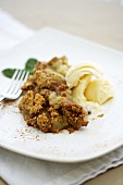 Serving of Apple Crisp with a Scoop of Vanilla Ice Cream on a Plate