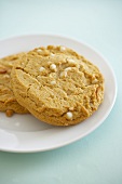 Two White Chocolate Chip Cookies with Almonds on a Plate