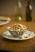 Bowl of Roasted Pumpkin Seeds on a Plate, Spoon