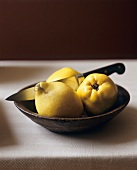 Three Whole Quince in a Bowl with a Knife