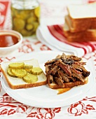 Opened Pulled Pork Sandwich with Pickles on White Bread