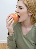 Woman Biting Into an Apple