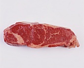 Raw Strip Steak on White