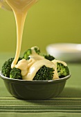 Pouring Melted Cheese Over Broccoli