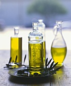 Assorted Bottles of Olive Oil with Fresh Olives and Leaves
