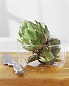 Two Artichokes in a Glass Bowl