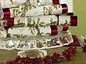 Christmas crackers on a cake stand with berry garland