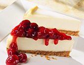 Two Slices of Cheesecake; One with Cherry Topping