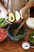 Man Holding Halved Avocado; Guacamole Ingredients