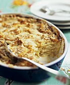 Cheesy Potato Casserole in Baking Dish with Scoop Removed
