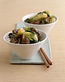 Bowls of Beef and Bok Choy Stir Fry Over Rice with Chopsticks