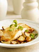 Cod Fillet Over Roast Potatoes and Garlic