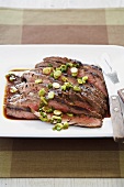 Sliced London Broil with Scallions on Platter