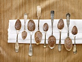 Nine Spoon Madeleines with Powdered Sugar on a White Napkin