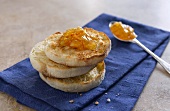 Stacked English Muffin Halves with Marmalade on Blue Towel