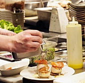 A Chef Preparing Scallops in a Restaurant Kitchen