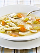 Bowl of Chicken Dumpling Soup with Spoon