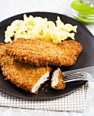 Breaded Pork Cutlets with Fork and Knife; Noodles