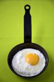 Fried Egg in Small Skillet; Green Background