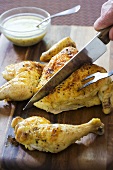 Carving Roast Lemon Chicken on Cutting Board