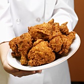 Chef Holding a Plate of Fried Chicken